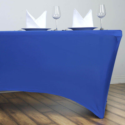 Blue tablecloth draped on a table with white napkins and glasses.