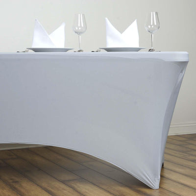 Gray table cover with plates and glasses set for a dining arrangement.