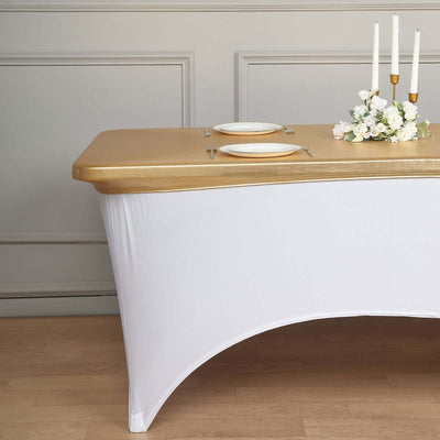 Elegant white table with gold accents and floral centerpiece, set for dining.