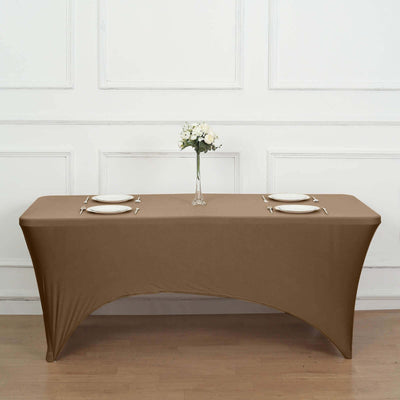 Brown table cover draped over a table with plates and a vase of flowers.