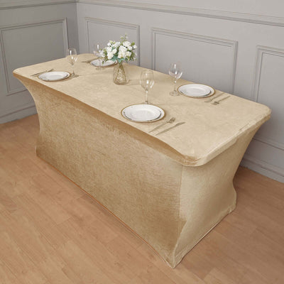 Elegant gold table cover with plates and glasses on a wooden floor setting.