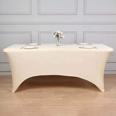 Elegant cream tablecloth draped over a table with floral centerpiece.
