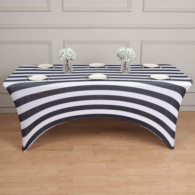 Striped table cover with plates and vases on a wooden floor