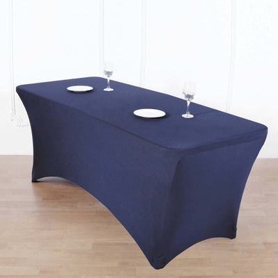 Navy blue table cover with plates and glasses on a wooden floor