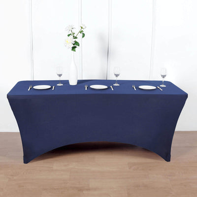 Navy blue table cover draped over a rectangular table with dinnerware set.