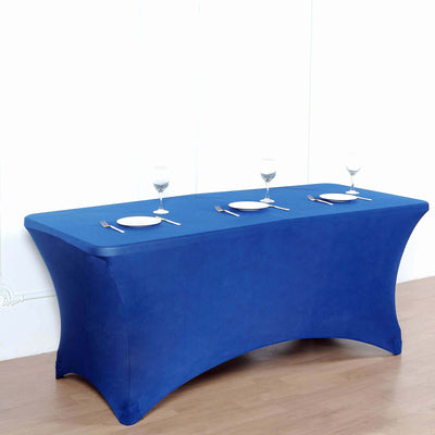 Blue table cover draped over a rectangular table set for dining.