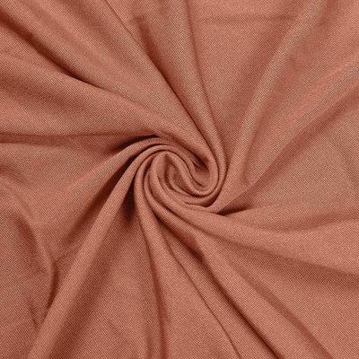 Textured rust fabric in a spiral pattern.