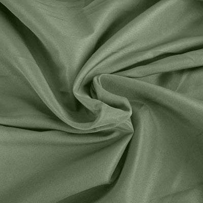 Textured green fabric draped elegantly in soft folds.