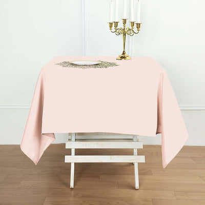 Pink tablecloth draped over a table with a decorative centerpiece.