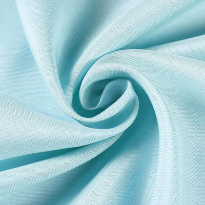 Soft light blue fabric texture in a swirling pattern.