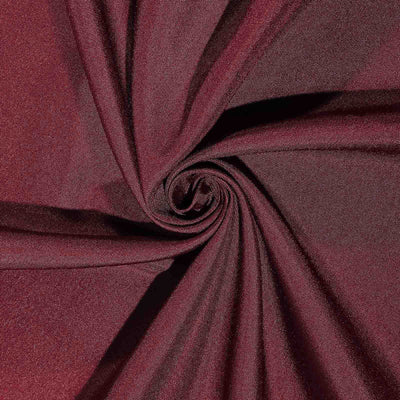 Burgundy fabric texture in a spiral pattern.