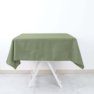 Green tablecloth on a white table against a plain backdrop.