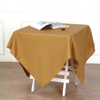 Brown tablecloth draped over a table with a magazine and tea cup.