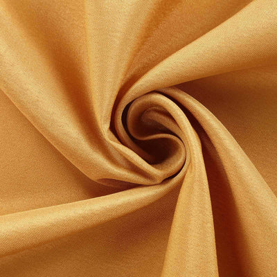 Golden fabric swirl showcasing smooth texture and sheen.