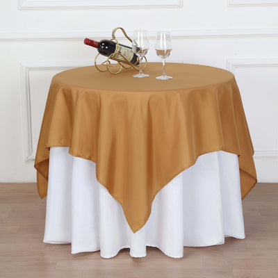 Brown tablecloth draped over a round table with wine and glasses.
