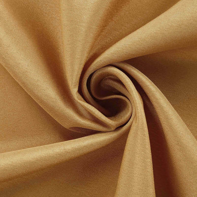 Golden fabric texture in a swirling pattern.