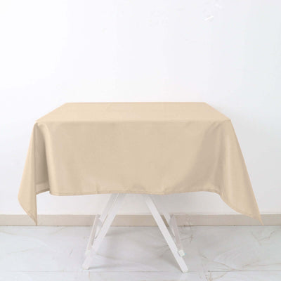 Beige tablecloth draped over a white folding table