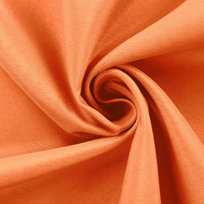 Orange fabric texture in a swirling pattern.
