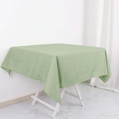 Green tablecloth draped over a white folding table.