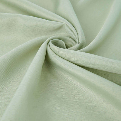Light green fabric texture in soft folds for stylish textile projects.