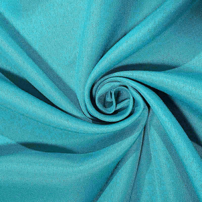 Turquoise fabric swirl showcasing texture and color.
