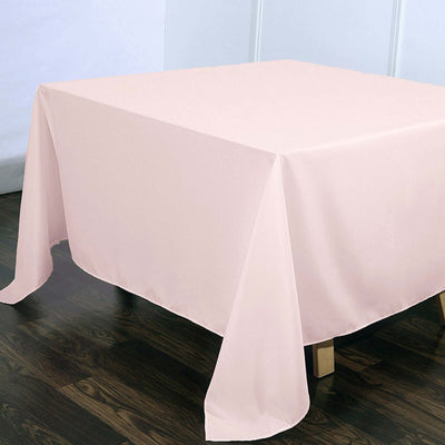 Pink tablecloth draped over a table in a minimalistic setting.