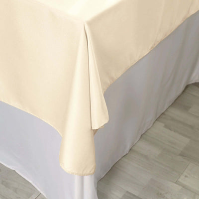 Beige tablecloth draped over a table corner, showcasing fabric texture.