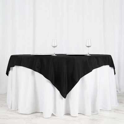 Elegant black tablecloth draped over a white table, perfect for formal dining settings.