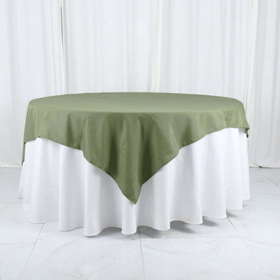 Round olive green tablecloth on a white table