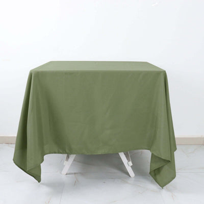 Green tablecloth draped over a table on a plain background