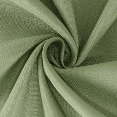 Green fabric texture in a swirling pattern.