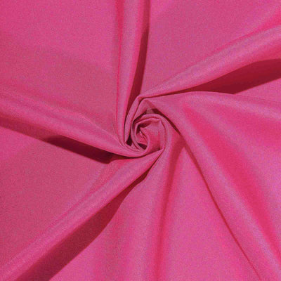 Bright pink fabric twisted in a spiral pattern showcasing its texture.