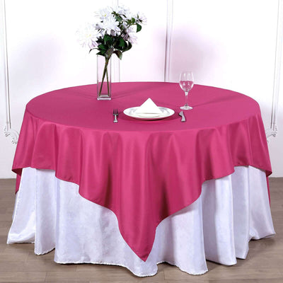 Pink tablecloth draped elegantly over a round table set for dining.