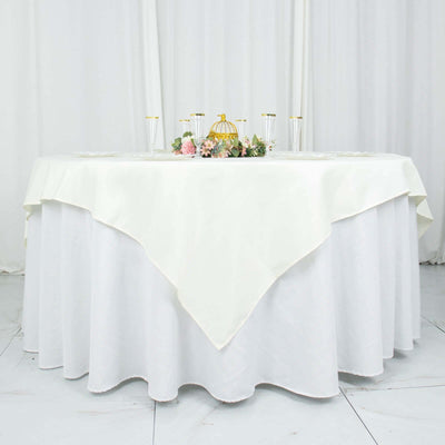 Elegant white tablecloth draped over a round table with floral centerpiece.