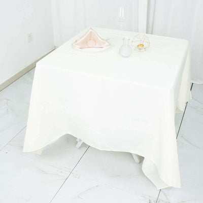 Elegant white tablecloth draped over a table with decorative items.