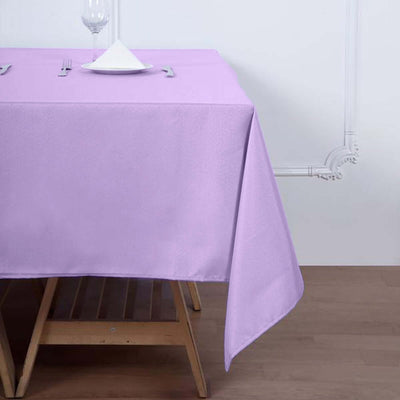 Purple tablecloth draped over a wooden table in a simple setting.