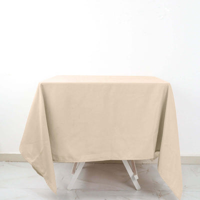 Beige tablecloth draped over a table on a white background.