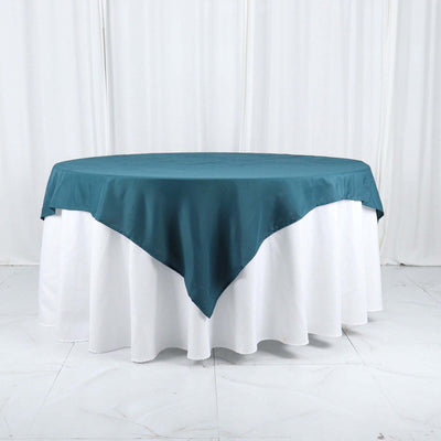Teal tablecloth draped over a white table for elegant dining.