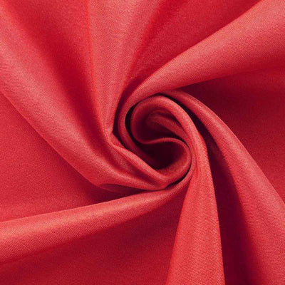 Red fabric texture in a swirling pattern, showcasing smooth, vibrant material.