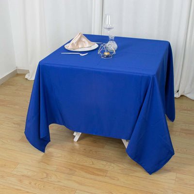 Blue tablecloth draped over a table with decorative items on top.