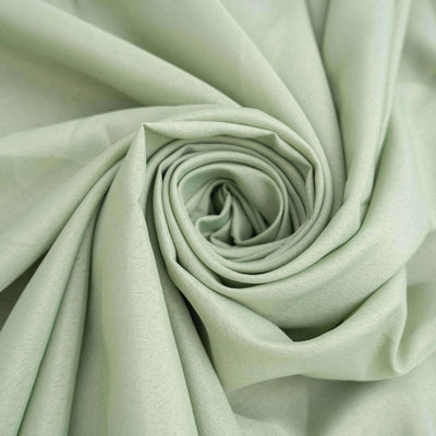 Light green fabric rolled in a spiral.