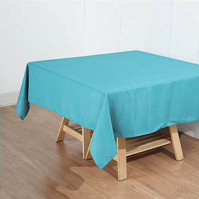 Turquoise tablecloth draped over a wooden table