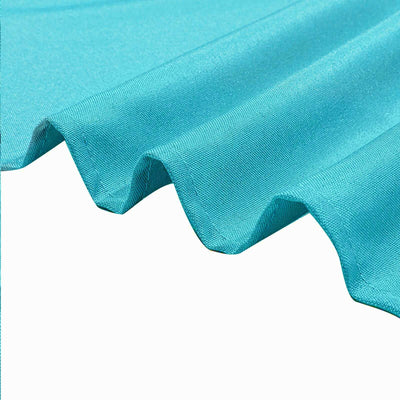 Teal fabric with a smooth texture and subtle wave detail.