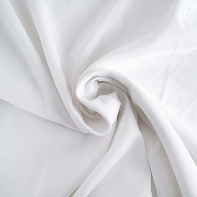 Smooth white fabric draped elegantly in soft folds.