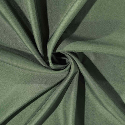 Green fabric texture in a swirling pattern.