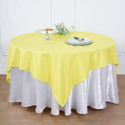 Yellow round tablecloth on a silver table covering for stylish dining.