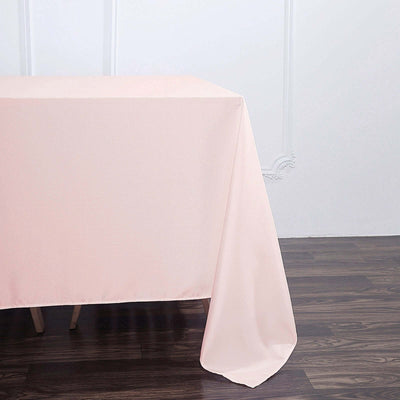 Pink tablecloth draped over a table, showcasing its smooth texture.