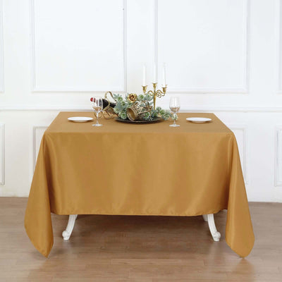 Elegant gold tablecloth draped over a table set for a festive dinner.