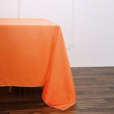 Orange tablecloth draped elegantly over a wooden table.
