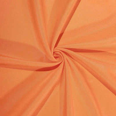Orange fabric with a smooth texture in a swirling pattern.